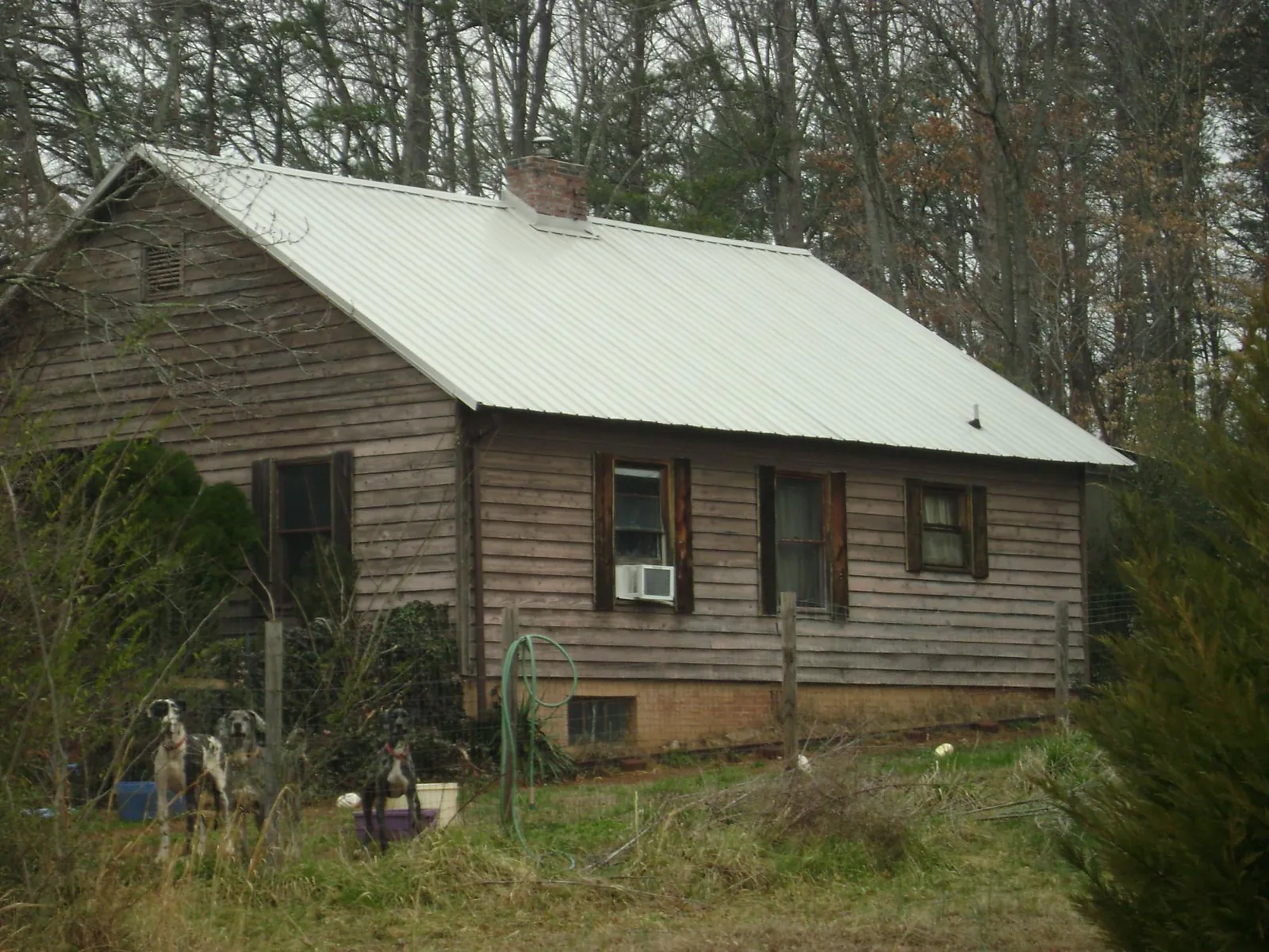 White metal roof on an old wood sided farmhouse, from a Asphalt Shingle Roof Repair job in Linwood